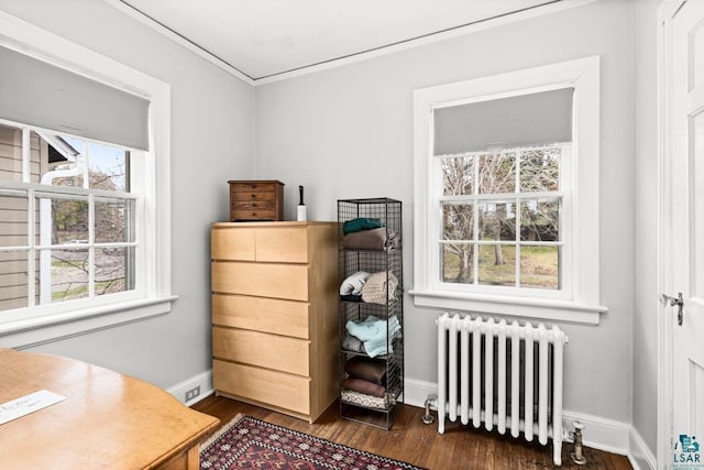 bedroom with baseboards, ornamental molding, radiator heating unit, and dark wood-style floors