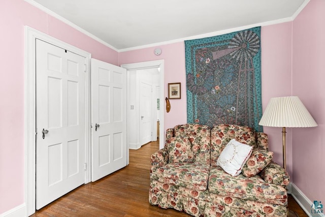 living area featuring crown molding and wood finished floors