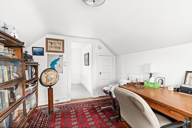 home office with vaulted ceiling and wood finished floors