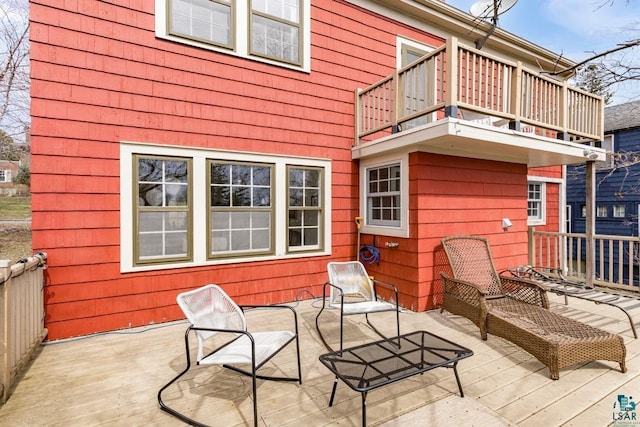 exterior space with a wooden deck and a balcony