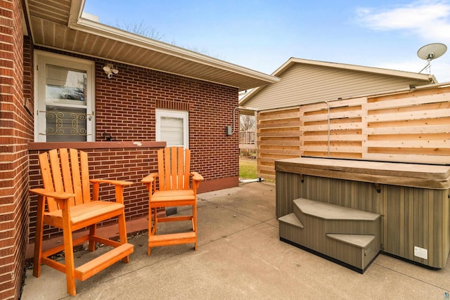 view of patio / terrace with a hot tub