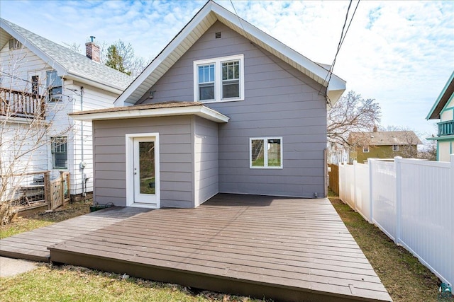 rear view of house with a fenced backyard and a wooden deck