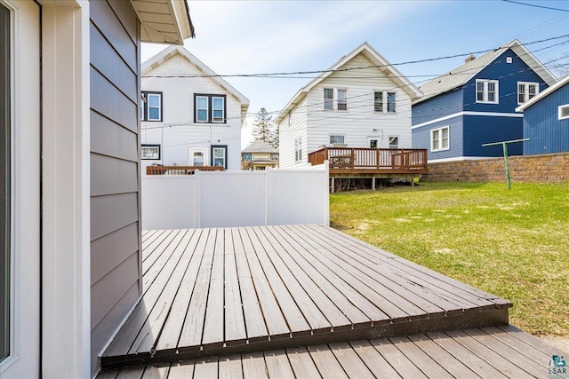 deck with a yard and fence