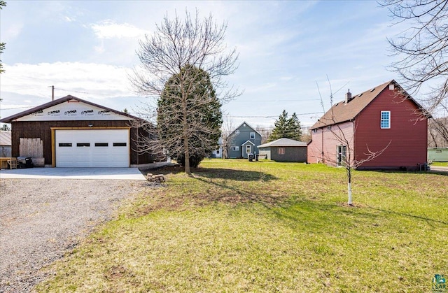view of yard featuring a garage and driveway