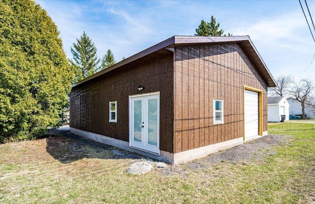 view of side of home with a yard, an outbuilding, and a garage
