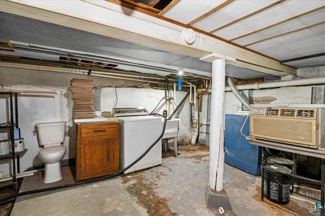 unfinished basement with washer / clothes dryer and a sink