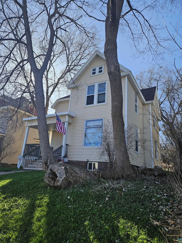 exterior space featuring a porch and a lawn