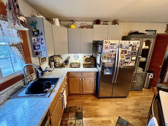 22 Hays Crk, Silver Bay, MN 55614 - kitchen with brown cabinets, stainless steel fridge, a sink, light countertops, and light wood-style flooring