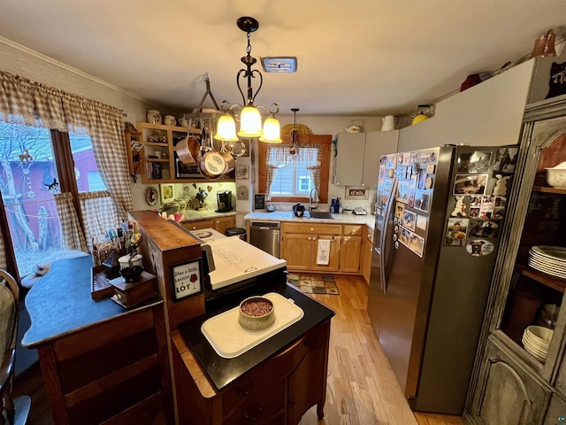 22 Hays Crk, Silver Bay, MN 55614 - kitchen featuring crown molding, appliances with stainless steel finishes, a sink, light wood-style floors, and pendant lighting