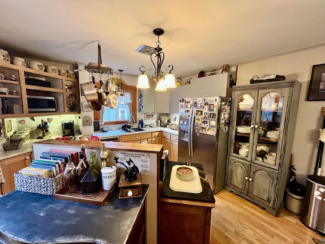 22 Hays Crk, Silver Bay, MN 55614 - kitchen with an inviting chandelier, a sink, light wood finished floors, stainless steel fridge with ice dispenser, and light countertops