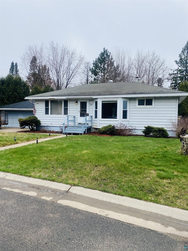 ranch-style home featuring a front yard