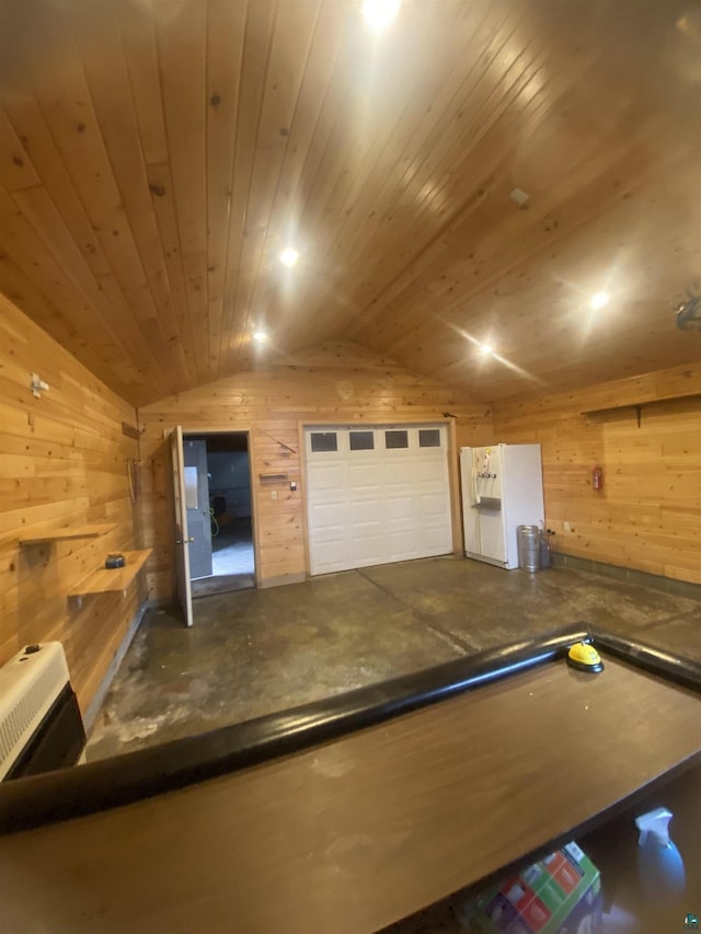 recreation room with lofted ceiling, wooden walls, concrete floors, and heating unit