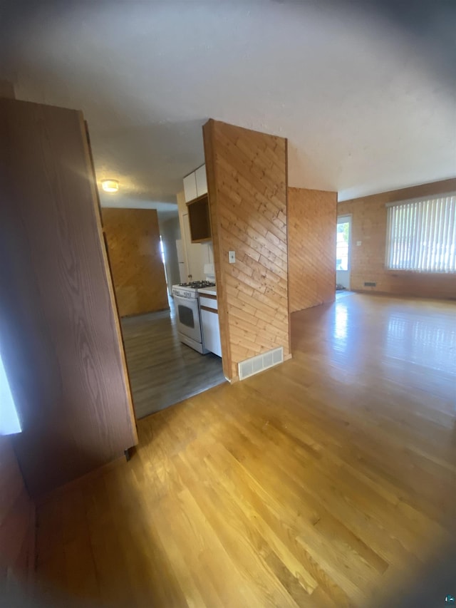 unfurnished room featuring light wood-type flooring and visible vents