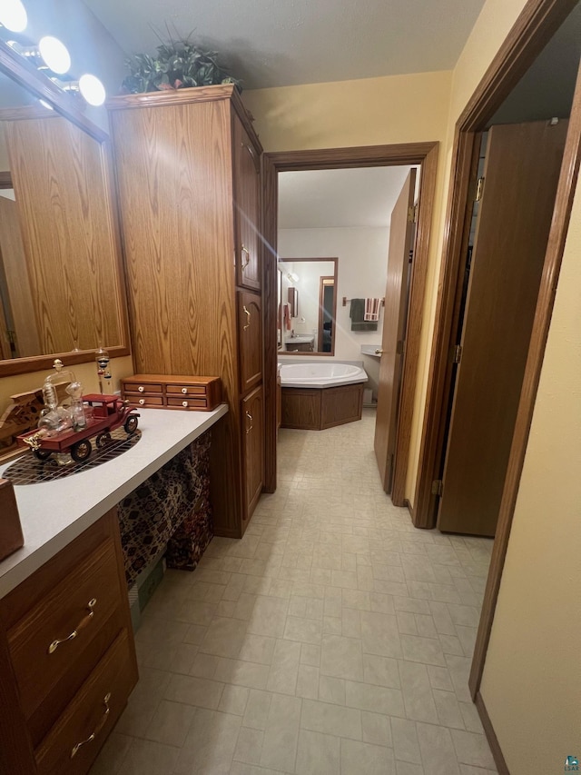 full bathroom with tile patterned floors, vanity, and a bath