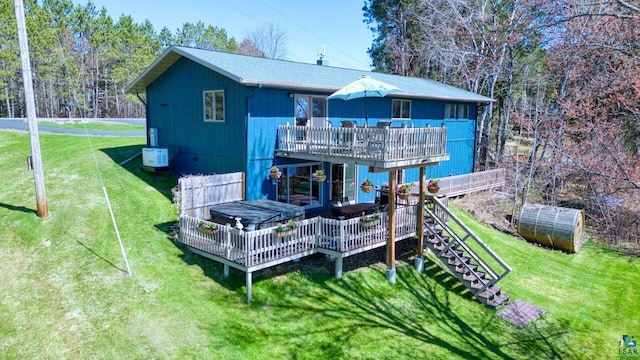 46040 State Highway 65, Nashwauk, MN 55769 - back of house featuring a lawn, an outbuilding, a greenhouse, stairs, and a deck