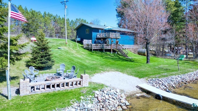 46040 State Highway 65, Nashwauk, MN 55769 - back of house with an outdoor fire pit, a yard, stairway, and a wooden deck