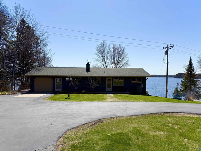 46040 State Highway 65, Nashwauk, MN 55769 - ranch-style house featuring a front yard, a water view, a garage, and aphalt driveway