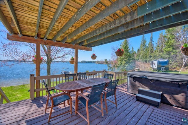 46040 State Highway 65, Nashwauk, MN 55769 - wooden terrace with a hot tub, a water view, and outdoor dining space