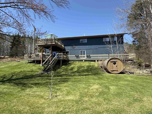 46040 State Highway 65, Nashwauk, MN 55769 - rear view of house featuring a lawn and a deck