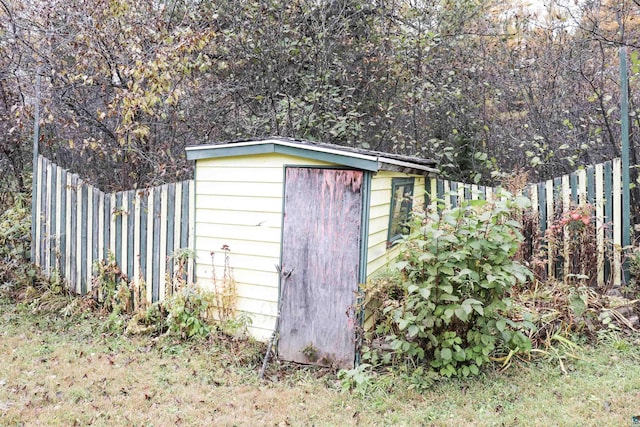 view of shed with fence
