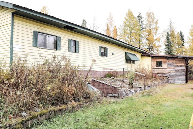 view of property exterior with a lawn