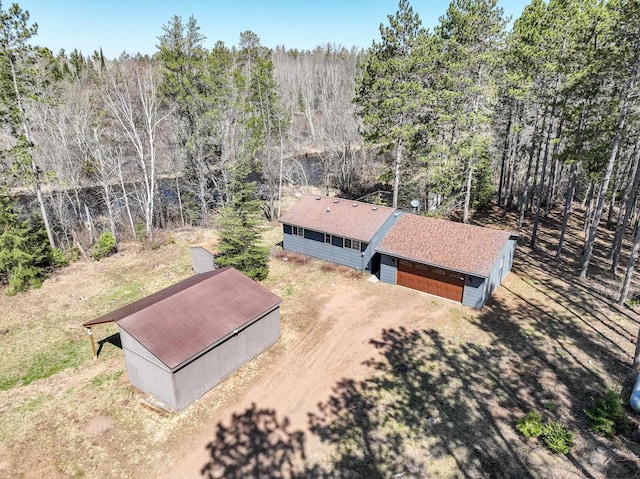 birds eye view of property with a wooded view