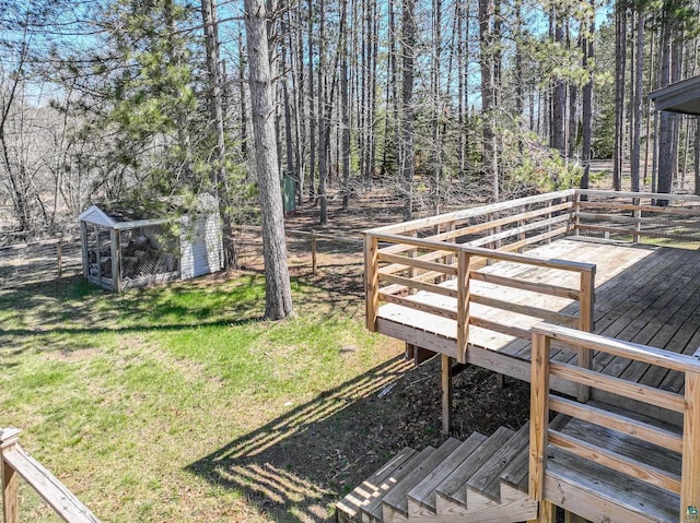 wooden deck with a yard and fence