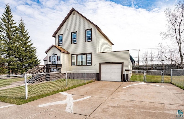view of front of home featuring concrete driveway, a garage, fence, and a front yard