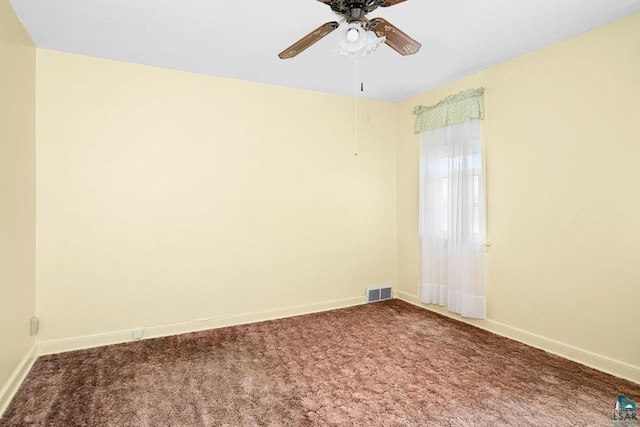 spare room featuring carpet flooring, visible vents, baseboards, and ceiling fan