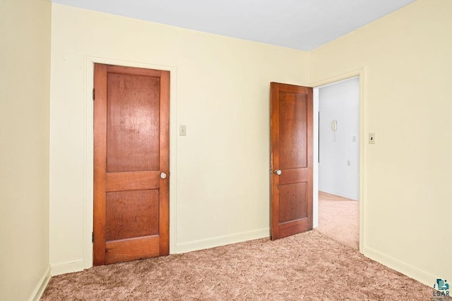 unfurnished room featuring baseboards and carpet floors