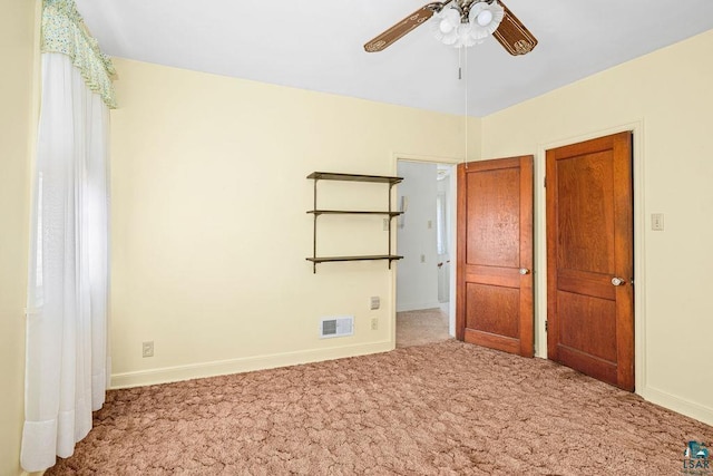 unfurnished bedroom featuring carpet floors, baseboards, and visible vents