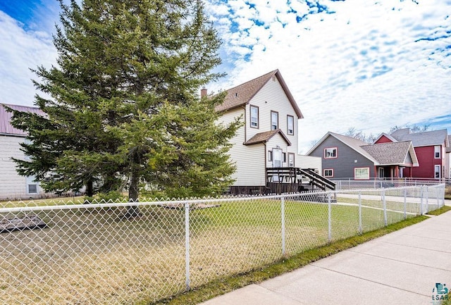 view of front of house with fence and a front yard
