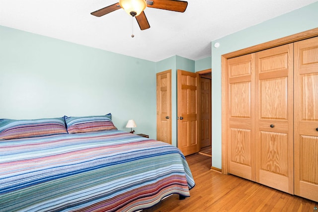 bedroom with light wood finished floors, a closet, and a ceiling fan