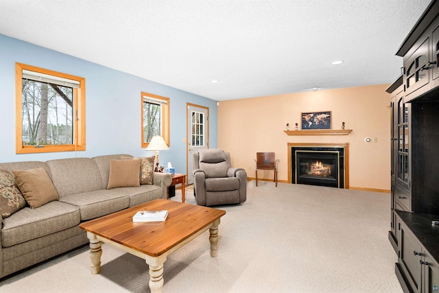 carpeted living room with baseboards, a tiled fireplace, and recessed lighting