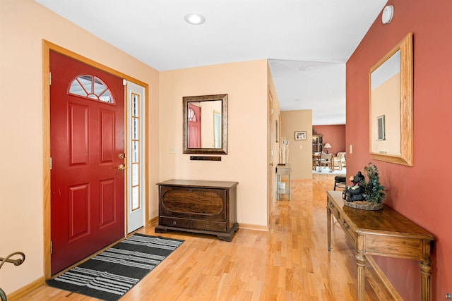 foyer entrance featuring wood finished floors, baseboards, and recessed lighting