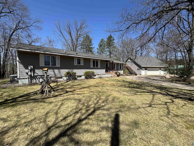 back of property featuring central AC, a yard, a porch, and a garage