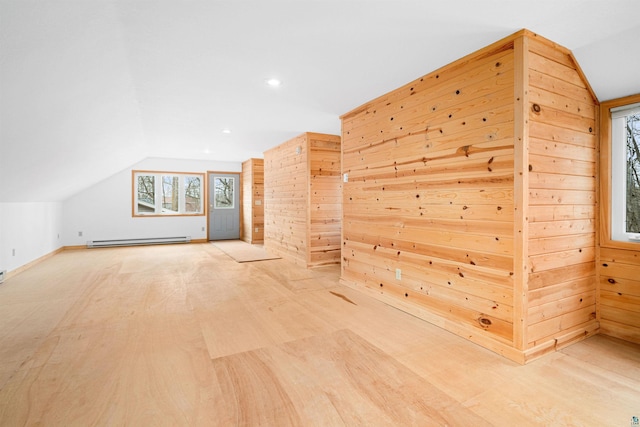 additional living space with wood finished floors, a baseboard radiator, baseboards, lofted ceiling, and recessed lighting