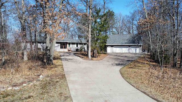 ranch-style house featuring concrete driveway