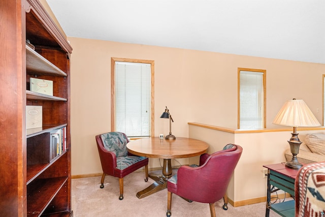 dining area featuring carpet and baseboards
