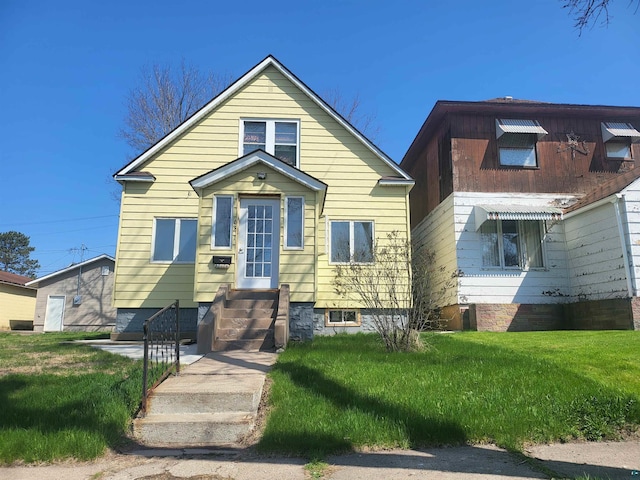 bungalow-style house with a front lawn