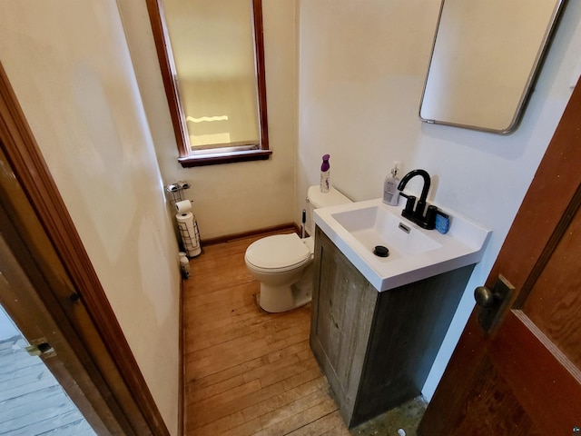 bathroom with vanity, hardwood / wood-style flooring, and toilet