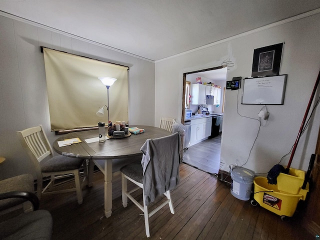 dining room with ornamental molding and hardwood / wood-style flooring