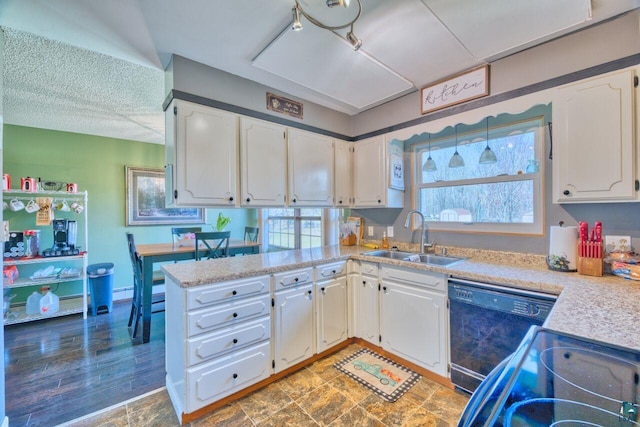 kitchen featuring white cabinetry, black appliances, light countertops, and a sink