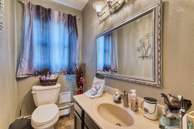 half bath featuring toilet, a baseboard radiator, vanity, and a textured wall