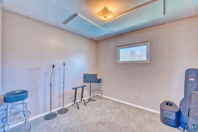 misc room with baseboards, attic access, and carpet floors