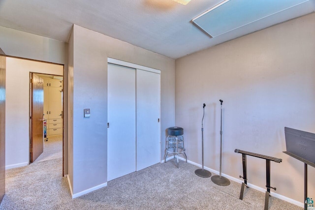 misc room with carpet, baseboards, and attic access