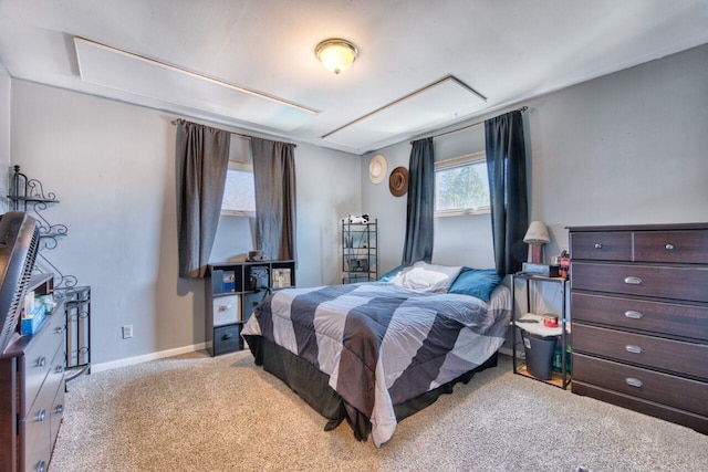 bedroom featuring light colored carpet and baseboards