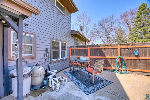 view of patio featuring fence and outdoor dining space
