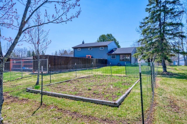 view of yard with a garden and fence