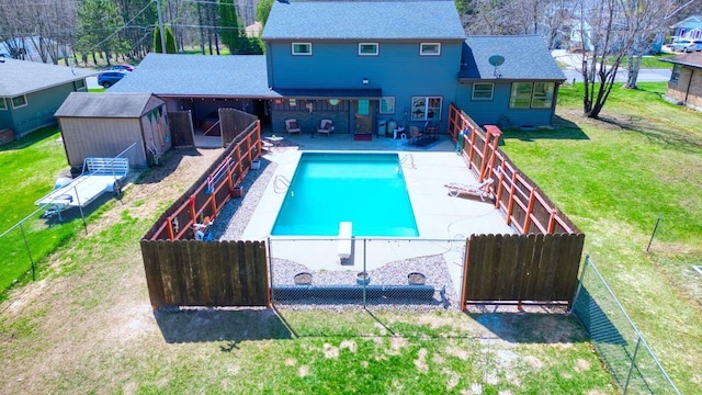 view of pool with a lawn, a patio area, a fenced in pool, and a fenced backyard